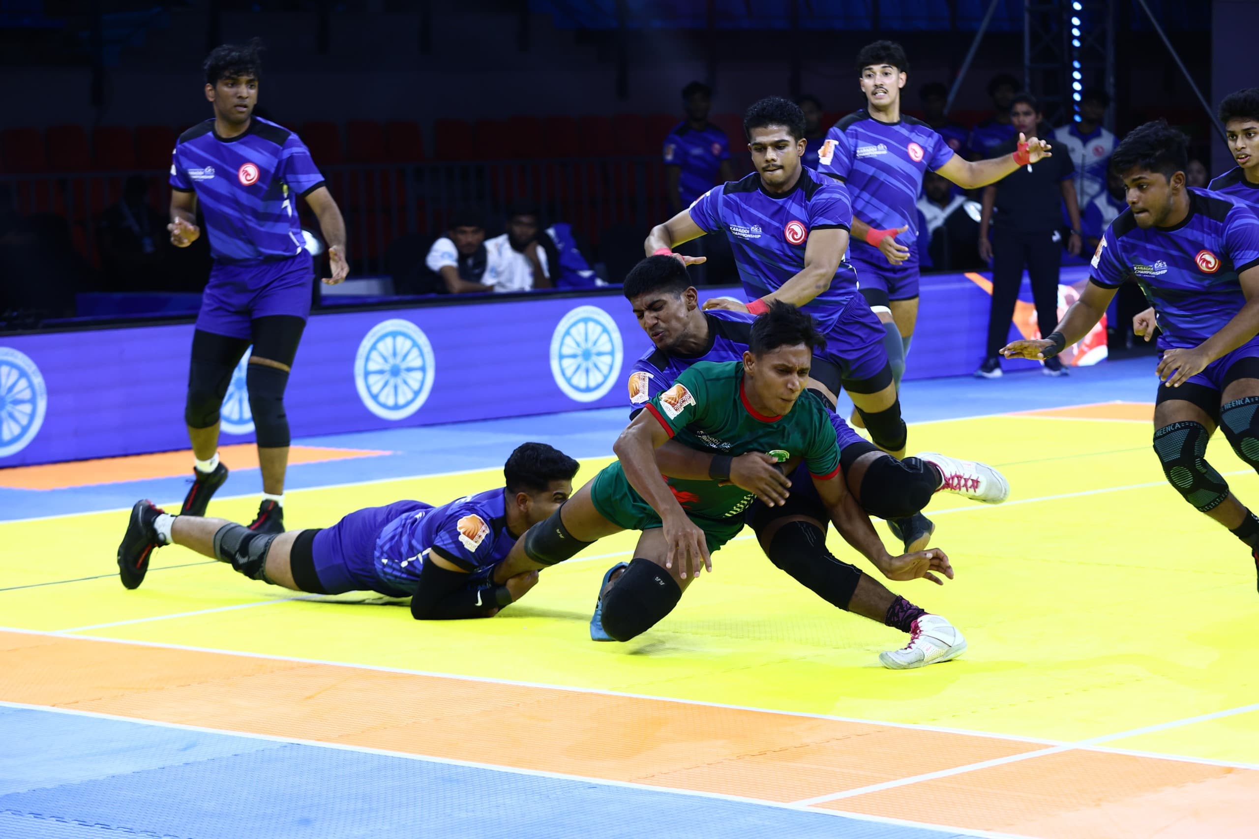 Singapore defenders bring down a Bangladesh raider at the Commonwealth Kabaddi Championship