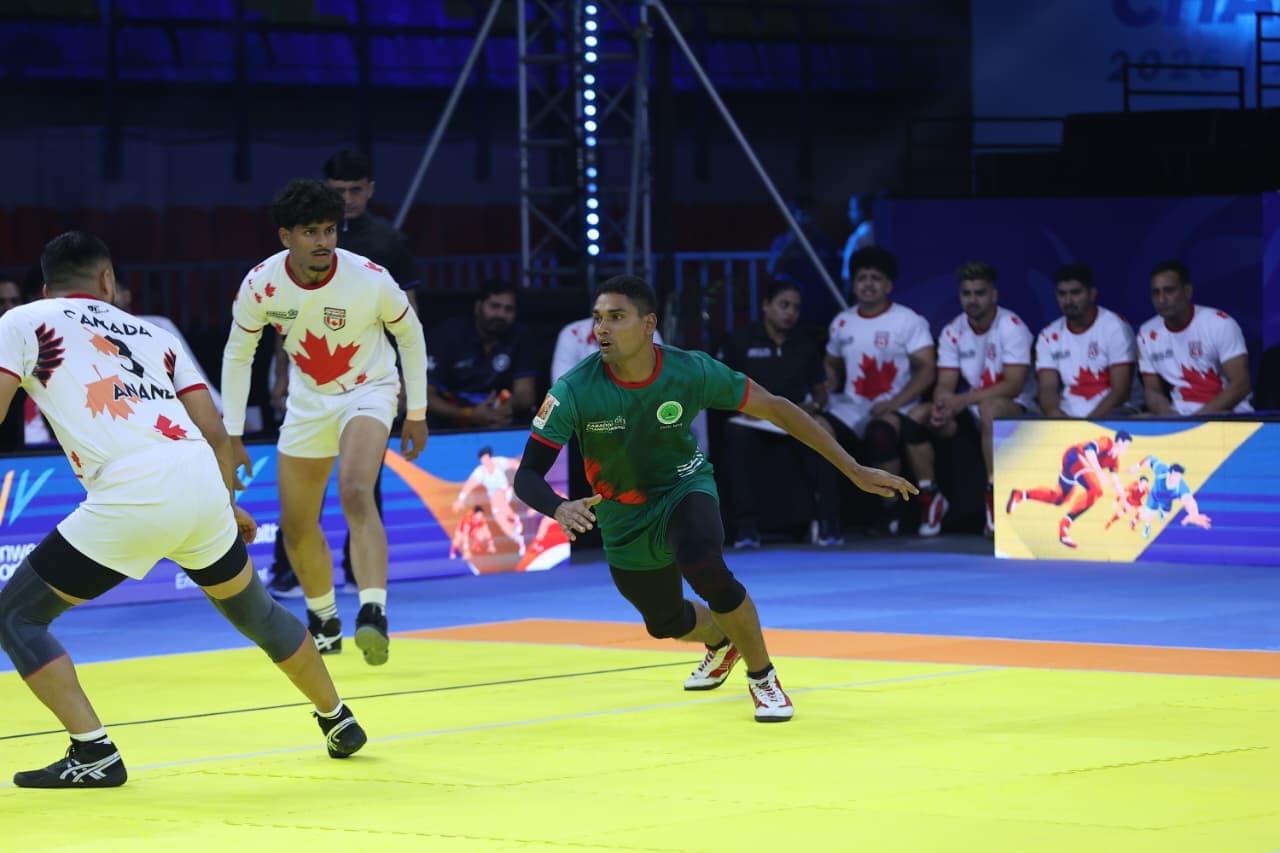 A Bangladesh raider takes on the Canada defence at the Commonwealth Kabaddi Championship