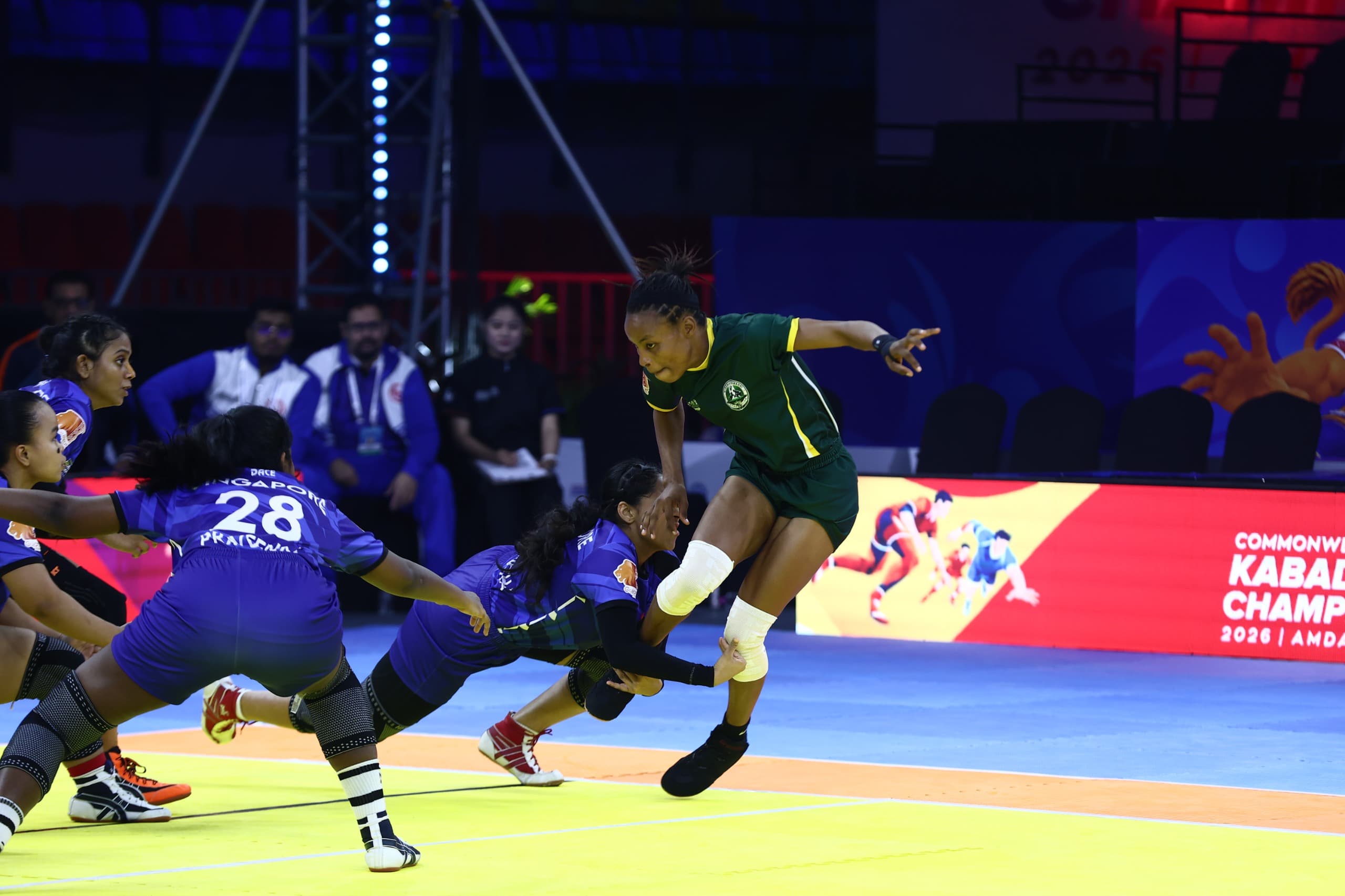 A Nigeria raider breaks free of Singapore's defence in the women's match in Ahmedabad