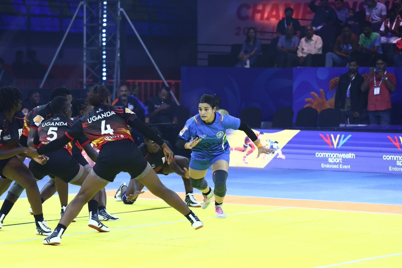 An India raider takes on Uganda's women's defence at the Commonwealth Kabaddi Championship in Ahmedabad