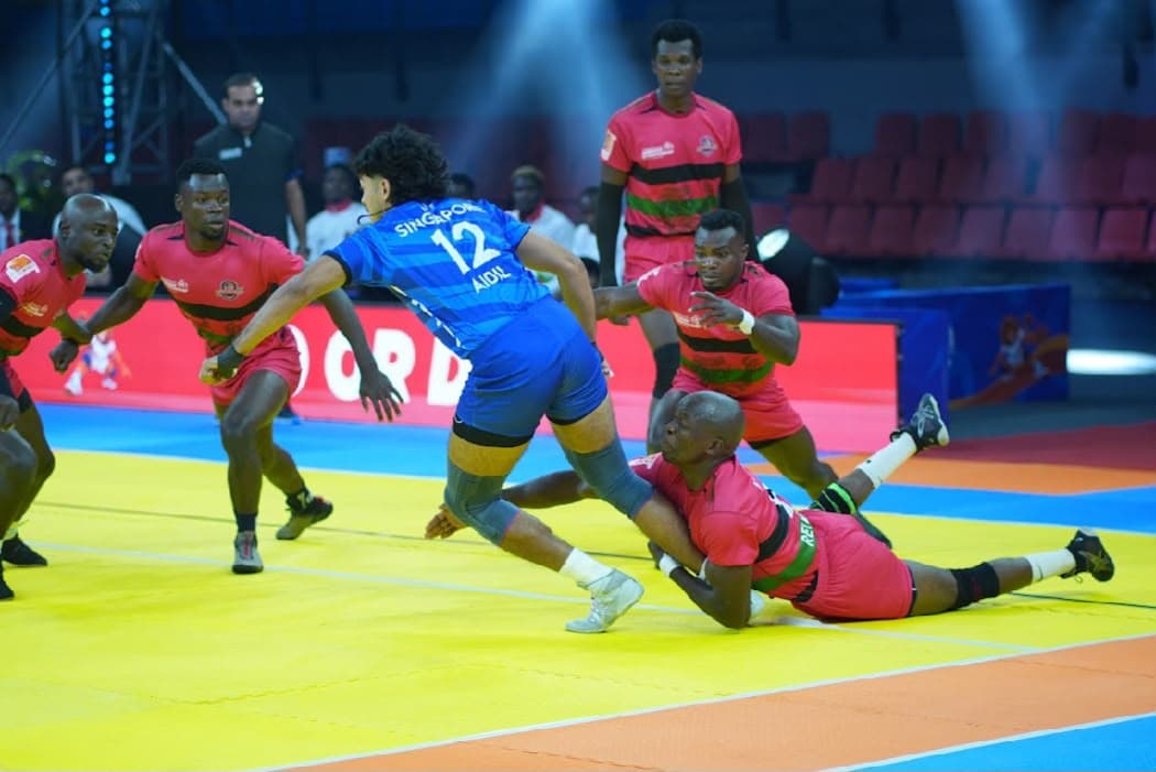 Singapore's Muhammad Aidil Mutalib raids against Kenya's men at the Commonwealth Kabaddi Championship